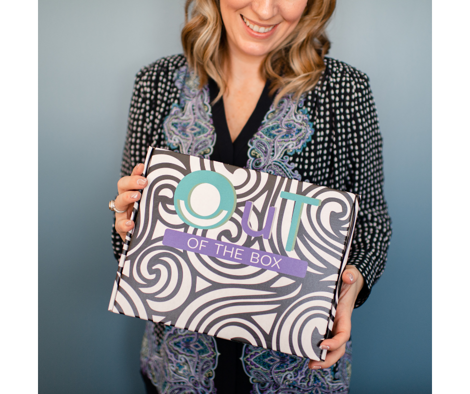 Ashley Lajoie holding an OuT of the Box occupational therapy box