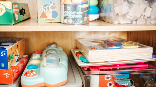 bookshelf of educational toys shown at Excel Therapy Services