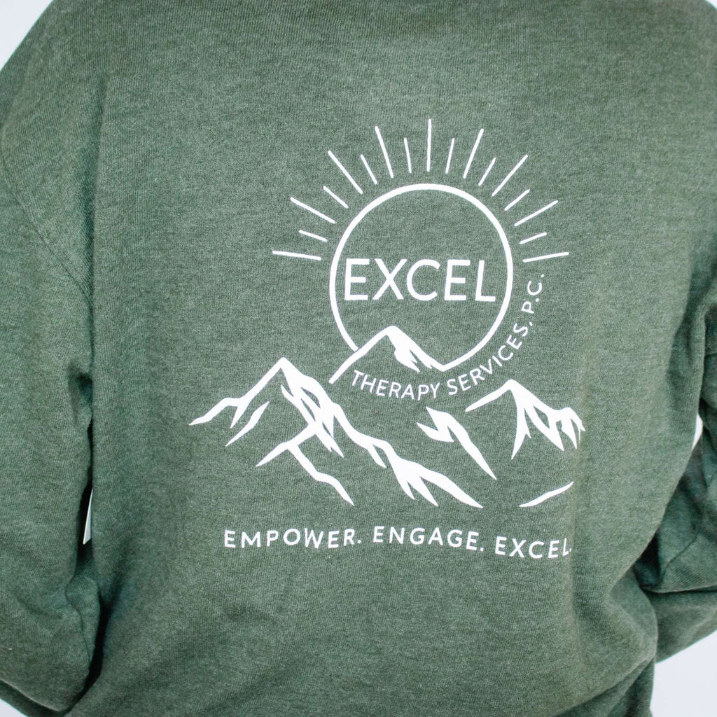 Green sweatshirt with Excel Therapy Services logo, featuring text and mountain illustration.